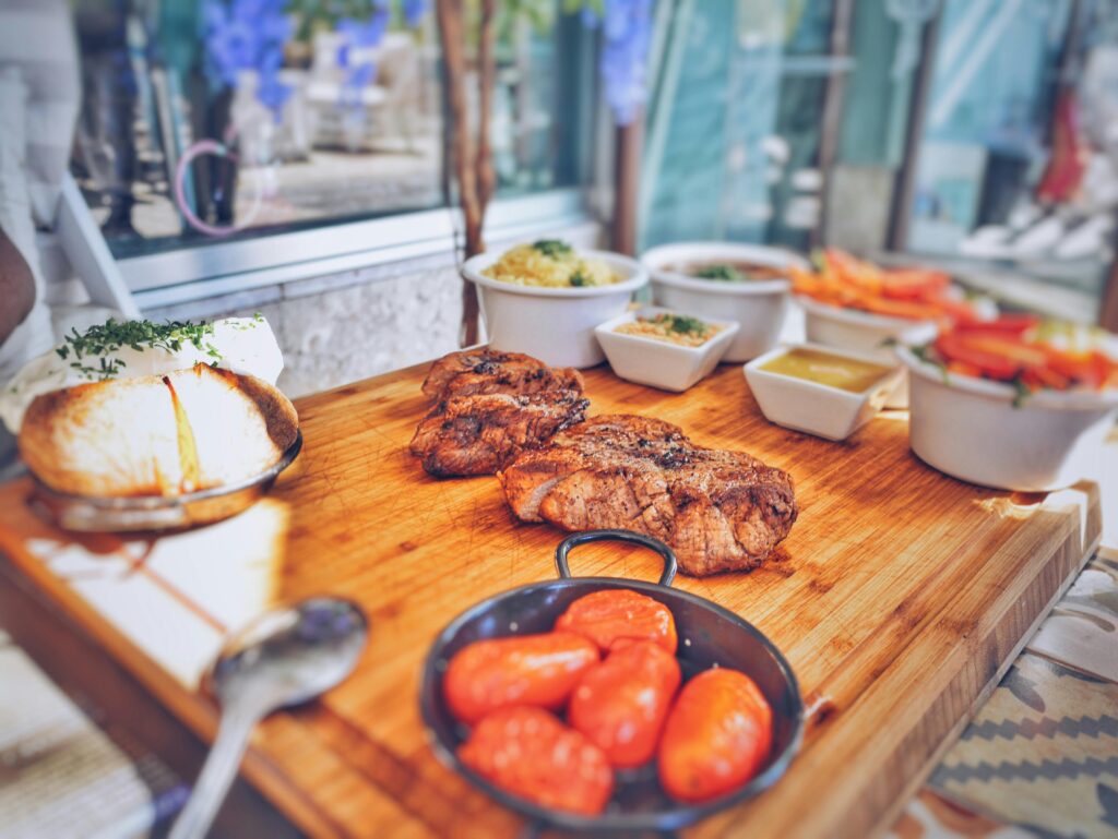 Savor the flavors of Portuguese cuisine with juicy beef and fresh vegetables in a rustic setting.